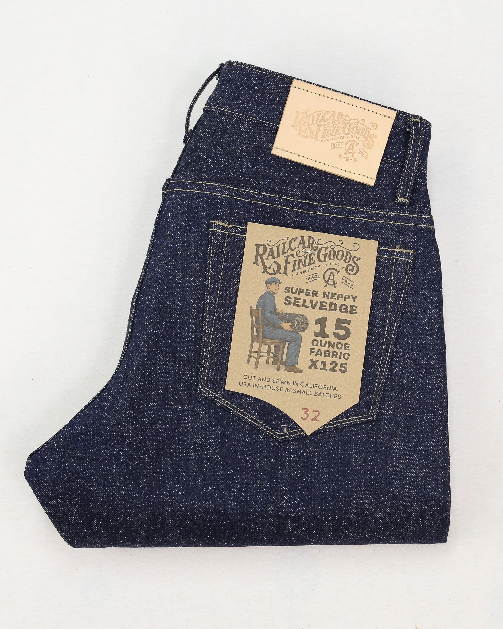 Folded pair of jeans with a brand label on a white background